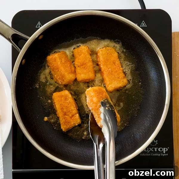 Gluten Free Breaded Fish with Homemade Tartar Sauce 8 Pan-frying breaded cod in a frying pan.