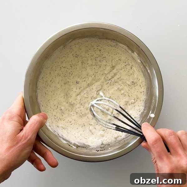 Gluten Free Breaded Fish with Homemade Tartar Sauce 9 Whisking a bowl of tartar sauce.