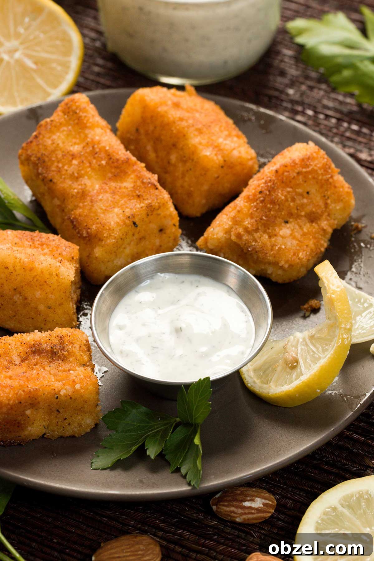 Gluten Free Breaded Fish with Homemade Tartar Sauce 10 Pan-fried cod on a plate with greek yogurt tartar sauce.