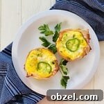 Spicy Jalapeno Popper Egg Cups Recipe 12 2 egg cups on a plate.