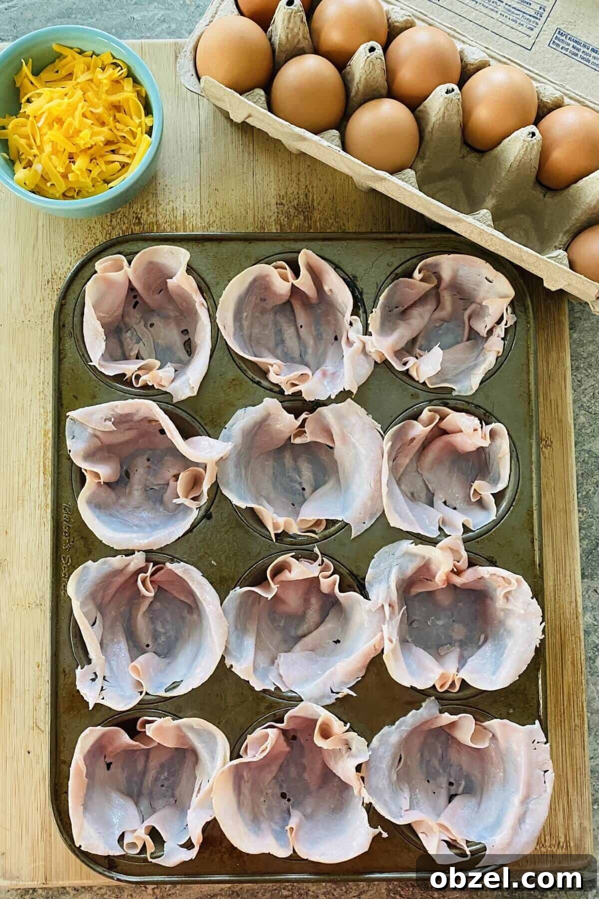 Spicy Jalapeno Popper Egg Cups Recipe 4 ham in a muffin pan.