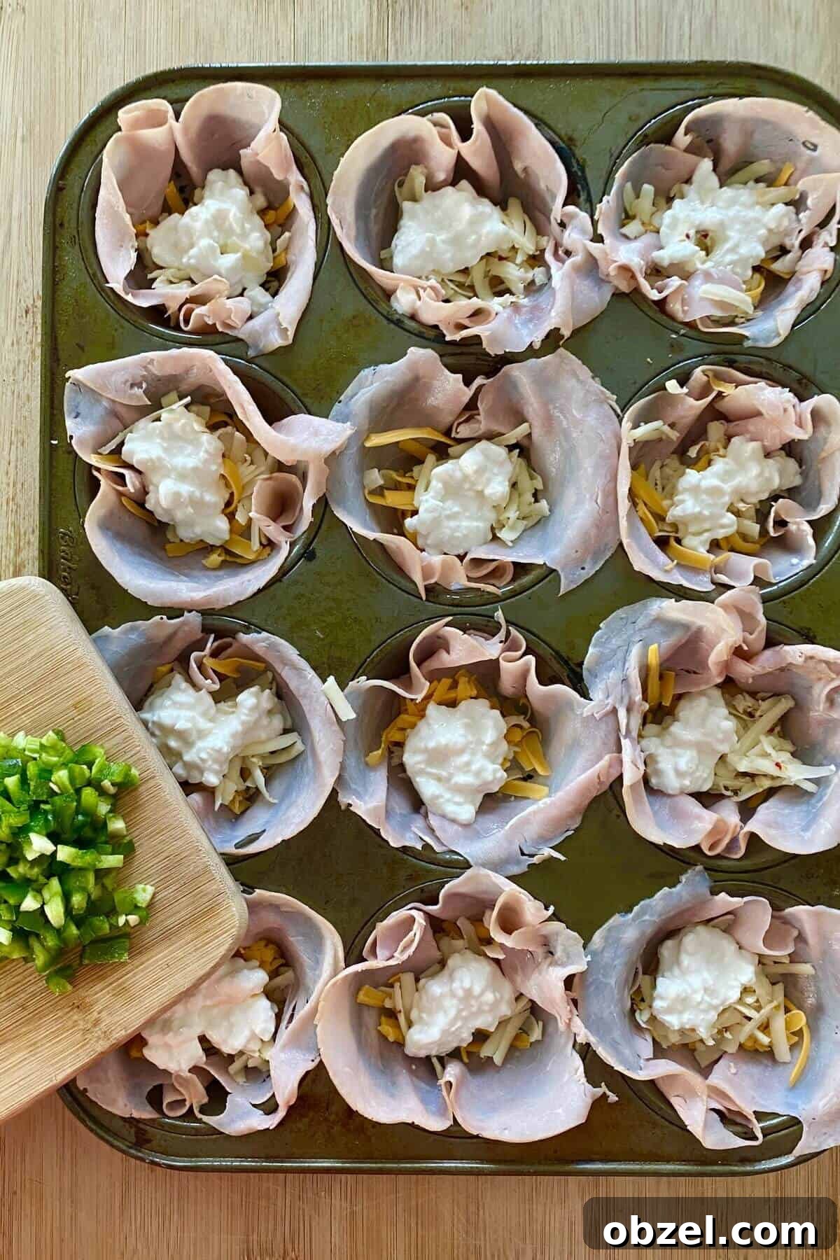 Spicy Jalapeno Popper Egg Cups Recipe 5 ham cups with 3 cheeses and chopped jalapeno.