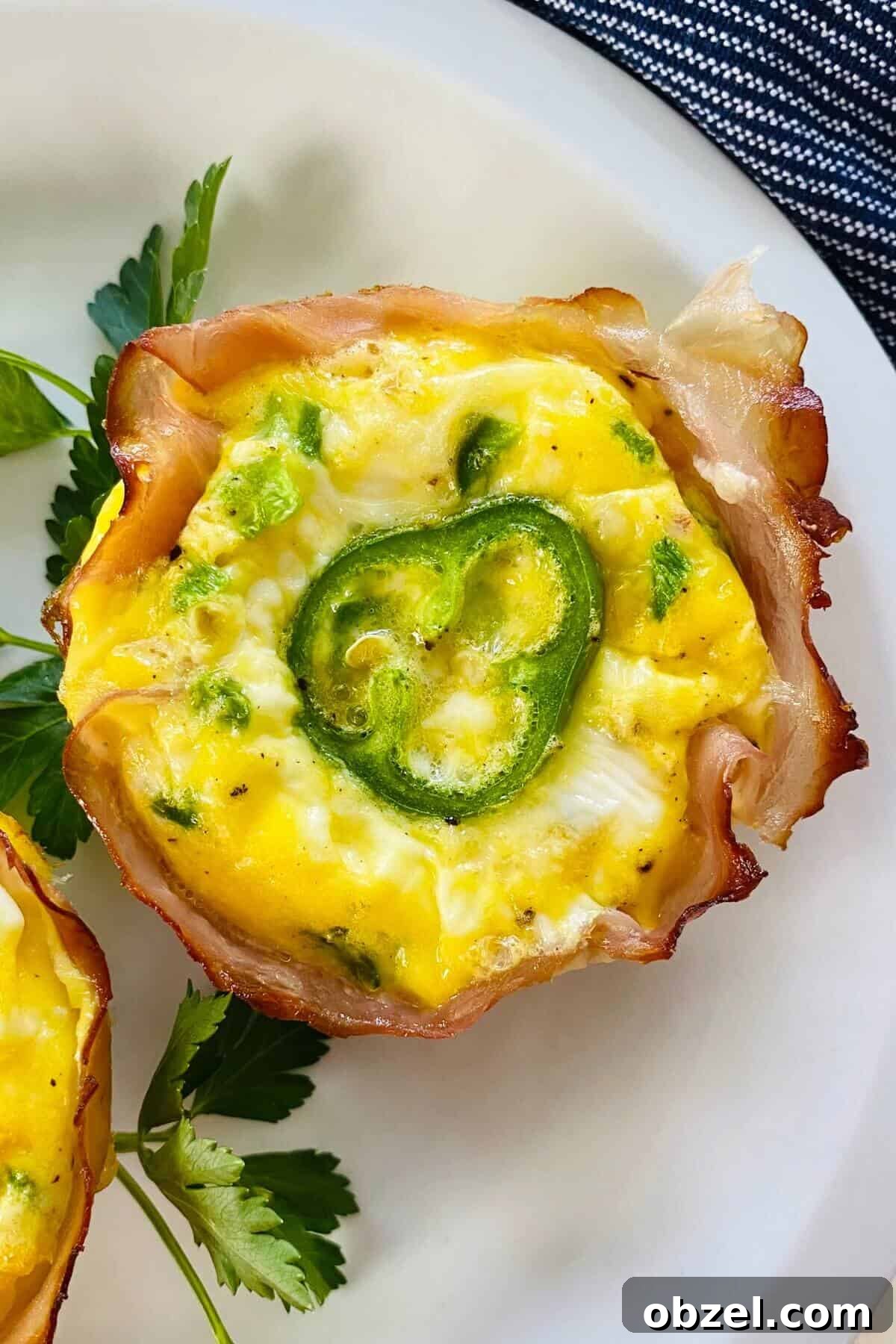 Spicy Jalapeno Popper Egg Cups Recipe 8 a single jalapeno popper egg cup on a plate.