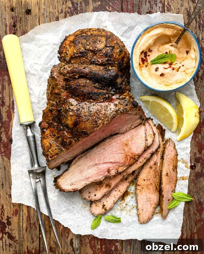 Marinated BBQ Boneless Leg of Lamb Recipe 2 Grilled boneless leg of lamb partly sliced on a wooden board