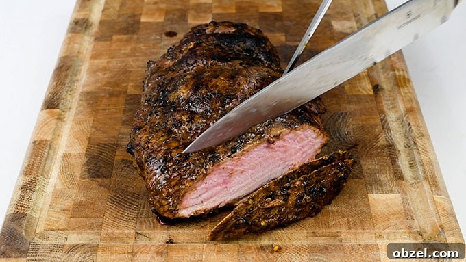 Marinated BBQ Boneless Leg of Lamb Recipe 10 Slicing BBQ boneless leg of lamb on a wooden board