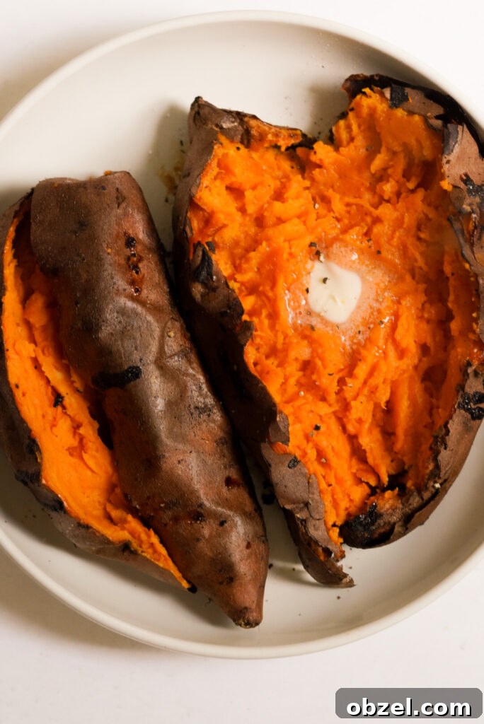Air Fryer Baked Sweet Potato with Crispy Skin 12 two air fried whole sweet potatoes on a plate