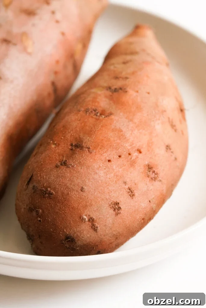 Air Fryer Baked Sweet Potato with Crispy Skin 5 a sweet potato with fork holes in it