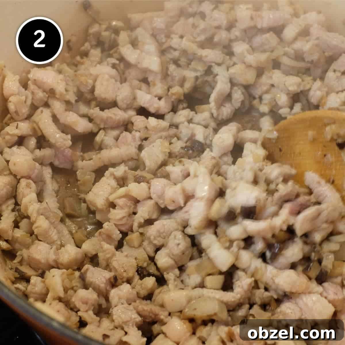 Stirring pork belly in a large pan