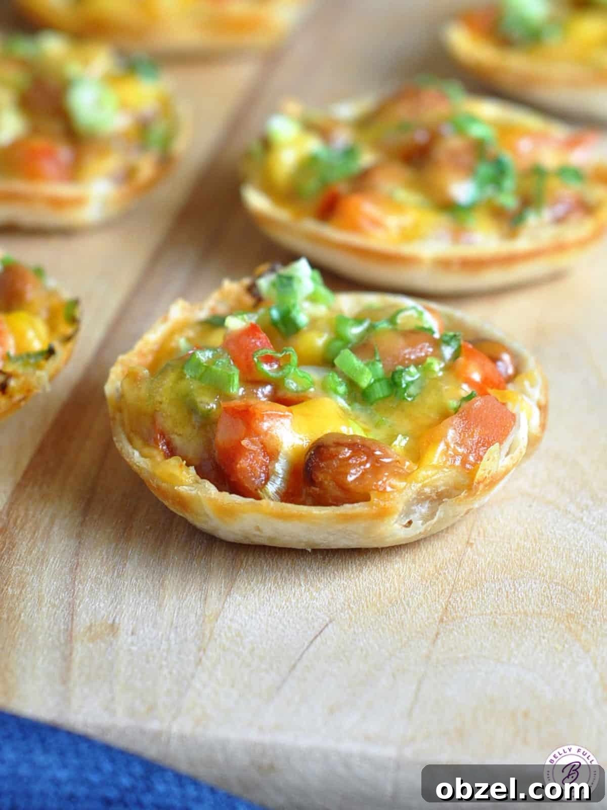Southwestern Mini Tostada Recipe: Flavorful Taco Bites 3 baked mini tortilla round filled with beans, corn, and cheese