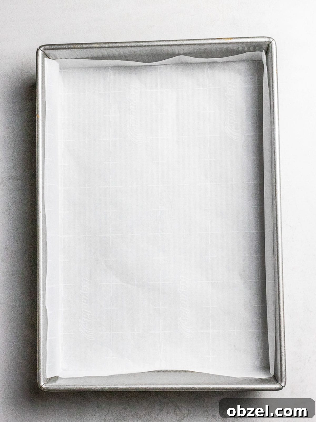 Bakery Style Swiss Roll Cake Recipe 9 Parchment paper fitted inside rectangular baking pan.