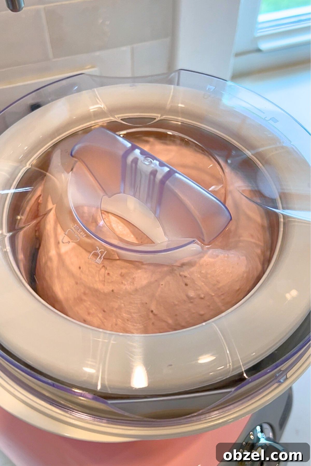 Churning the strawberry ice cream base in the Cloudy Pink Ankarsrum Assistent Original Mixer and ice cream maker attachment.