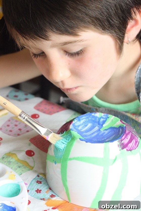 child painting bowl with tape resist technique