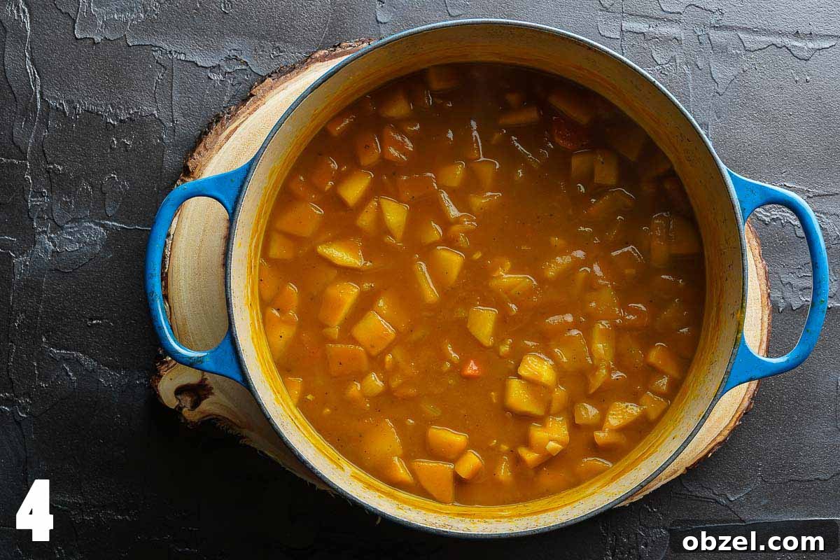 Velvety Carrot, Pumpkin and Apple Soup Recipe 7 carrot pumpkin apple soup in blue pot prior to blending