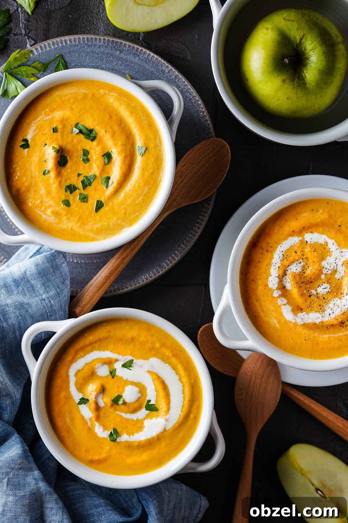 Velvety Carrot, Pumpkin and Apple Soup Recipe 9 Carrot pumpkin apple soup in three bowls with wooden spoons