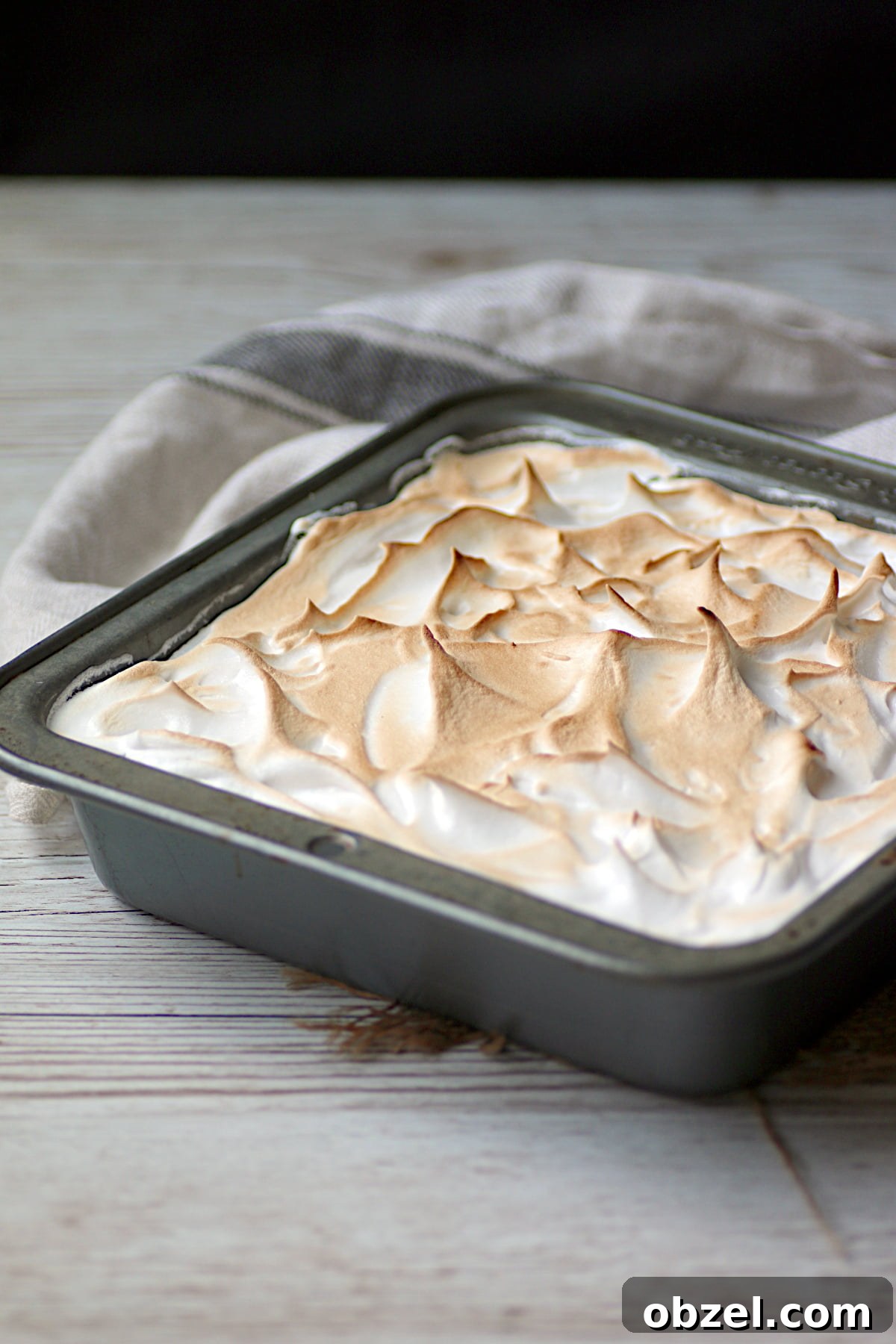Strawberry Rhubarb Meringue Bars Recipe 2 Strawberry Rhubarb Meringue Squres in a square baking pan.