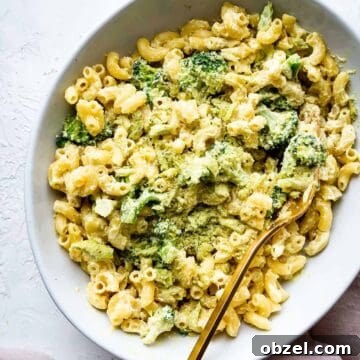 Creamy Vegan Mac and Cheese Recipe 2 vegan mac and cheese made with cashew cheese in a bowl with a gold fork and broccoli