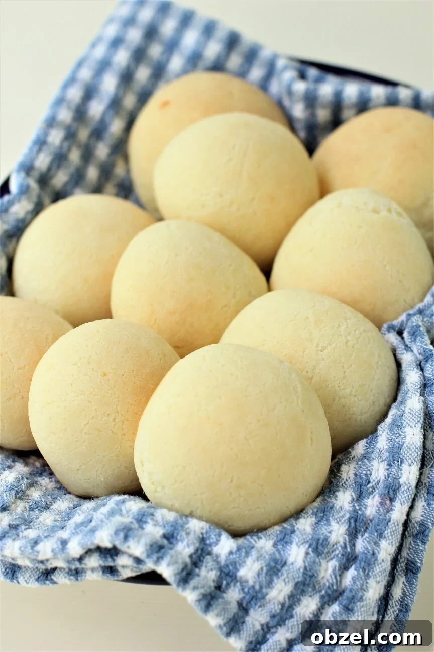 Pan de Yuca Warm Colombian Cheese Bread Rolls 2 fresh pan de yuca cheese buns on a tea towel