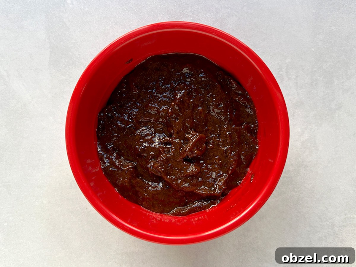 How to Make Lekvar Prune Butter at Home 11 Lekvar in a red bowl ready to use or mix with nuts.