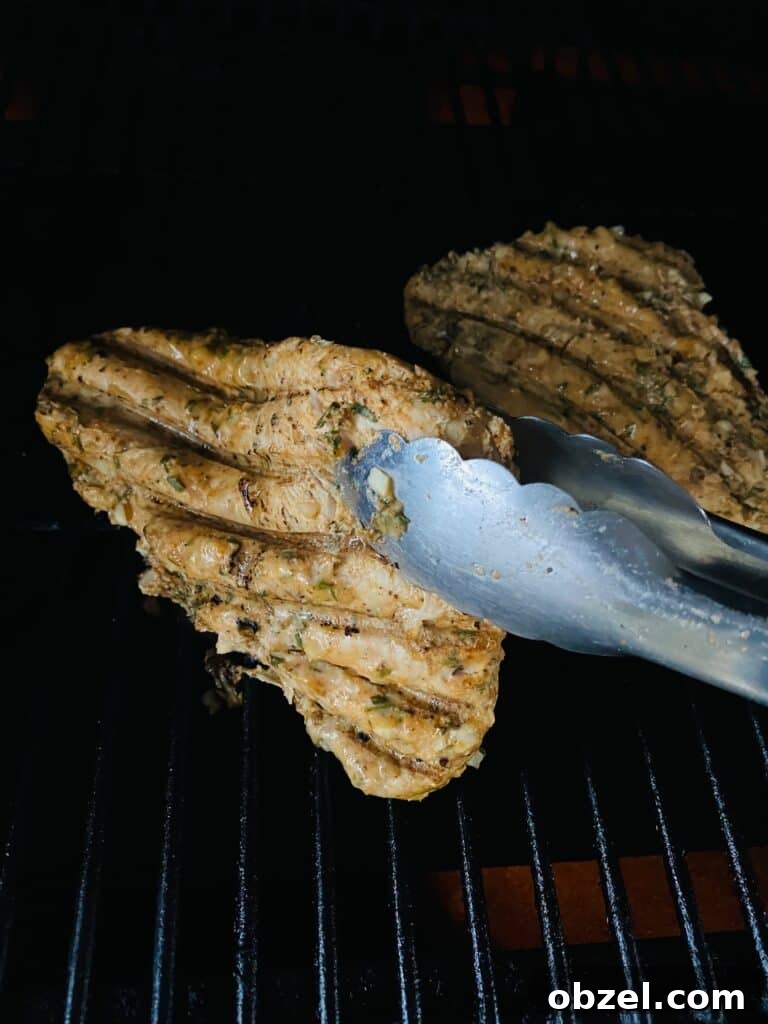 Traeger Lemon Herb Turkey Tenderloin Recipe 5 flipping the Traeger Lemon Herb Turkey Tenderloins with tongs