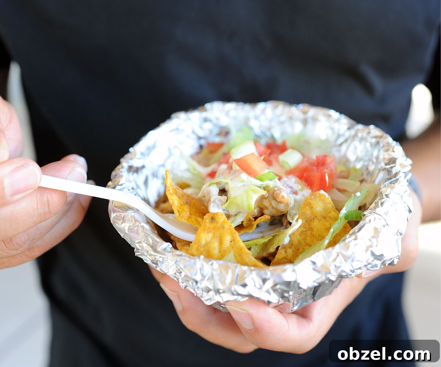 man holding walking taco foil packet