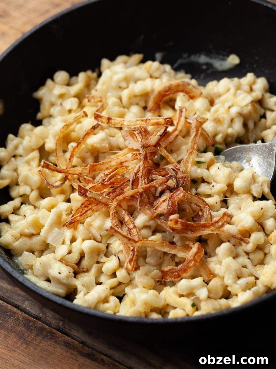 gluten free Kasspatzle topped with crispy onions in a skillet