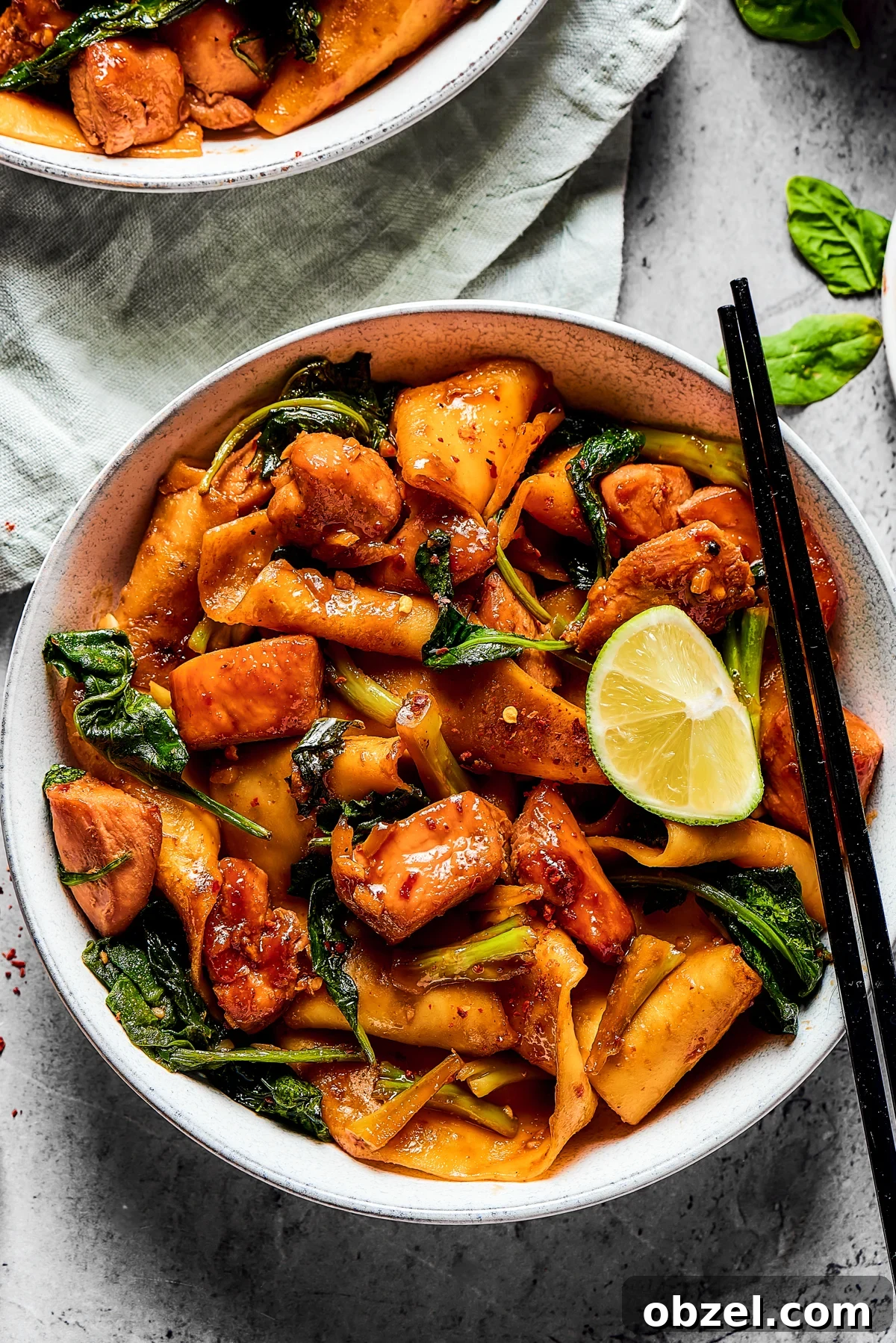 Stir-fried chicken and noodles with broccoli and spinach.