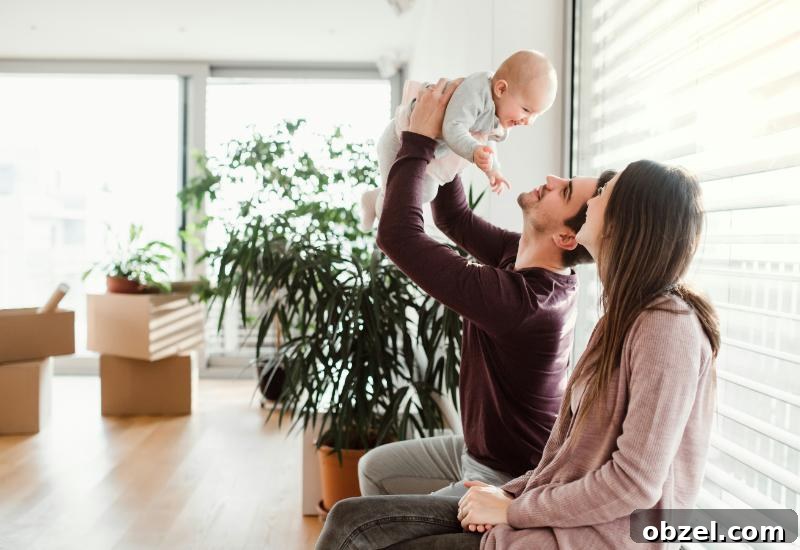 How to Balance Work and Family After Moving to a New City 3 mom and dad playing with baby, moving boxes in background