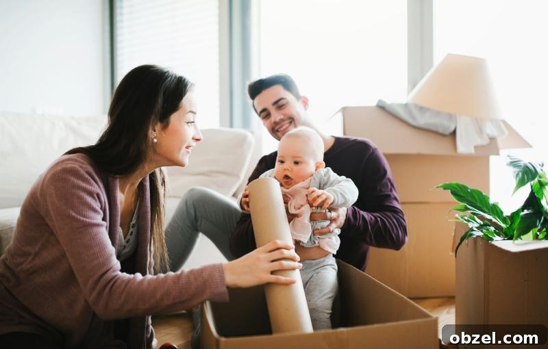 How to Balance Work and Family After Moving to a New City 4 mom unpacking boxes while dad holds baby
