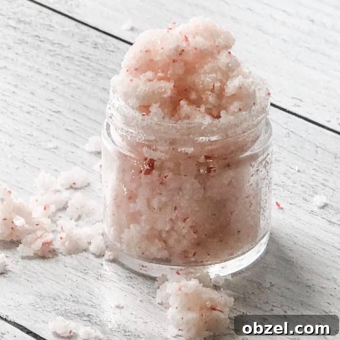 DIY Peppermint Candy Cane Lip Scrub for Soft Lips 11 peppermint candy cane lip scrub with essential oils overflowing in small open glass jar