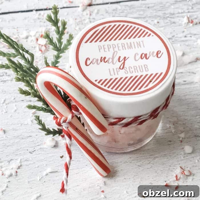 DIY Peppermint Candy Cane Lip Scrub for Soft Lips 13 peppermint candy cane lip scrub with essential oils in glass jar with custom label, candy cane and twig garnish tied to jar