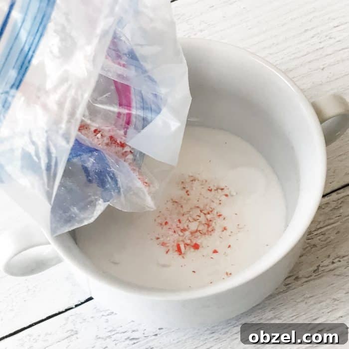 DIY Peppermint Candy Cane Lip Scrub for Soft Lips 7 adding smashed candy cane pieces to bowl with sugar for use in peppermint candy cane lip scrub with essential oils