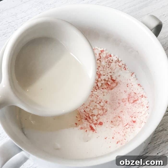 DIY Peppermint Candy Cane Lip Scrub for Soft Lips 9 adding peppermint essential oil and apricot kernel oil to candy cane pieces and sugar in creation of peppermint candy cane lip scrub with essential oils