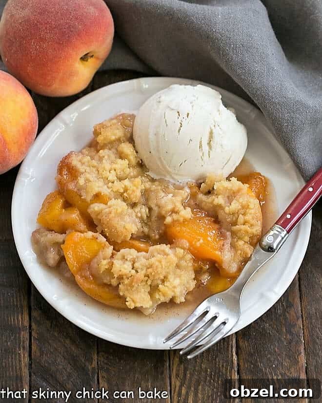 Classic Peach Crisp - Sweetened peaches with a buttery, brown sugar crisp topping Overhead view of a Classic Peach Crisp on a white plate with a scoop of vanilla ice cream.
