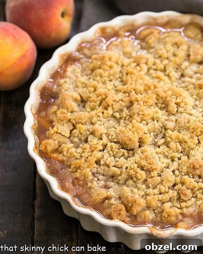 Classic Peach Crisp - Sweetened peaches with a buttery, brown sugar crisp topping Classic Peach Crisp in a round scalloped casserole dish