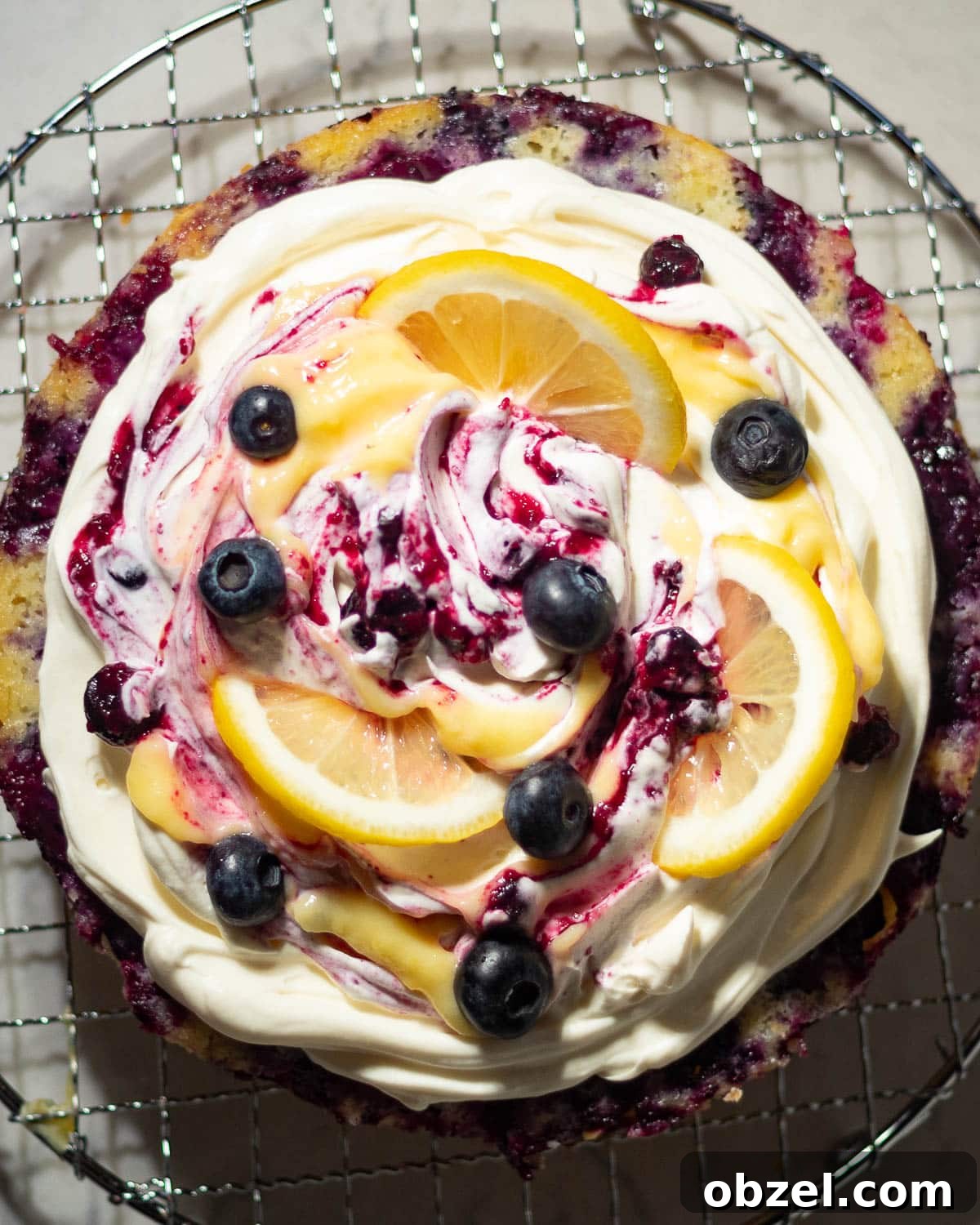 Lemon Blueberry Cake with Mascarpone Frosting 15 Whole lemon blueberry mascarpone cake topped with mascarpone cream, lemon curd, blueberry compote, and lemon slices.