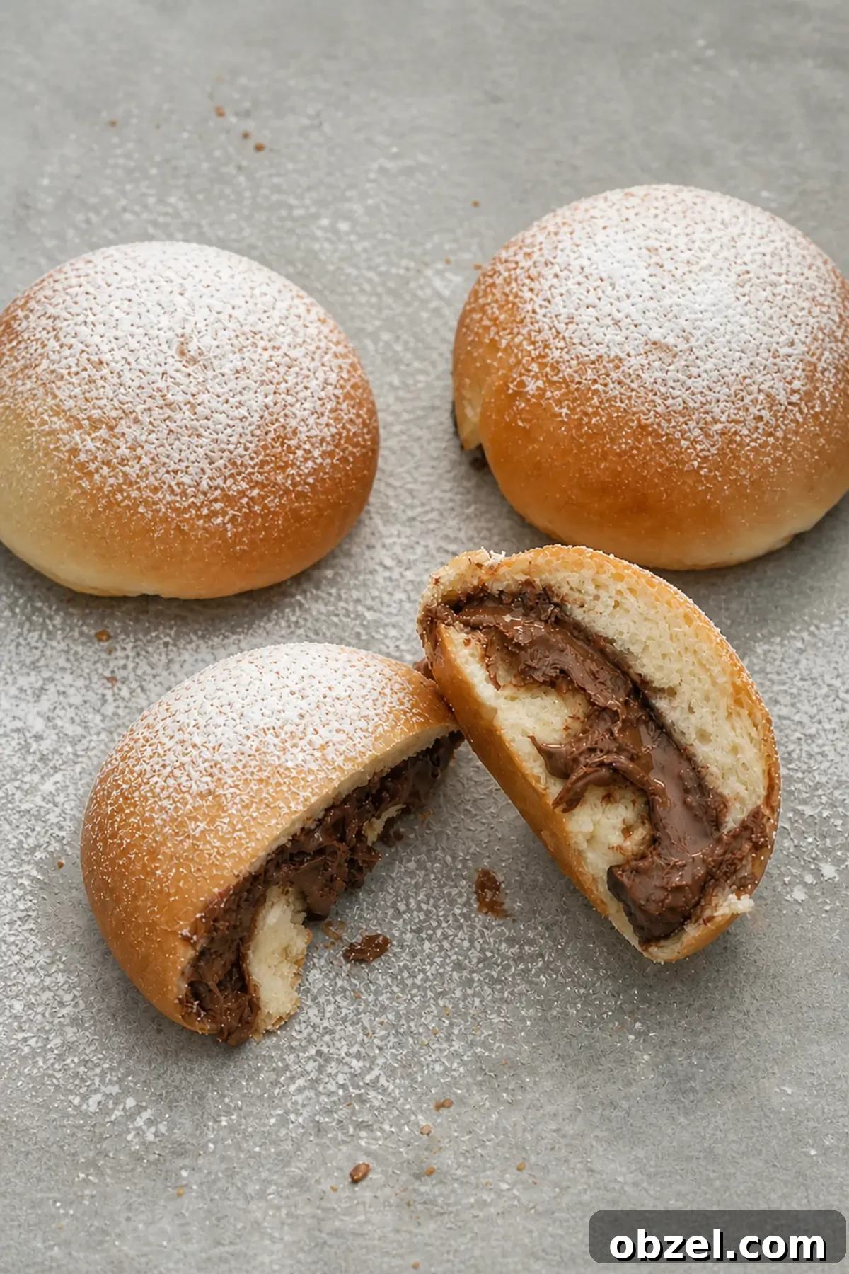 Soft Italian Nutella buns with powdered sugar and creamy chocolate filling inside.
