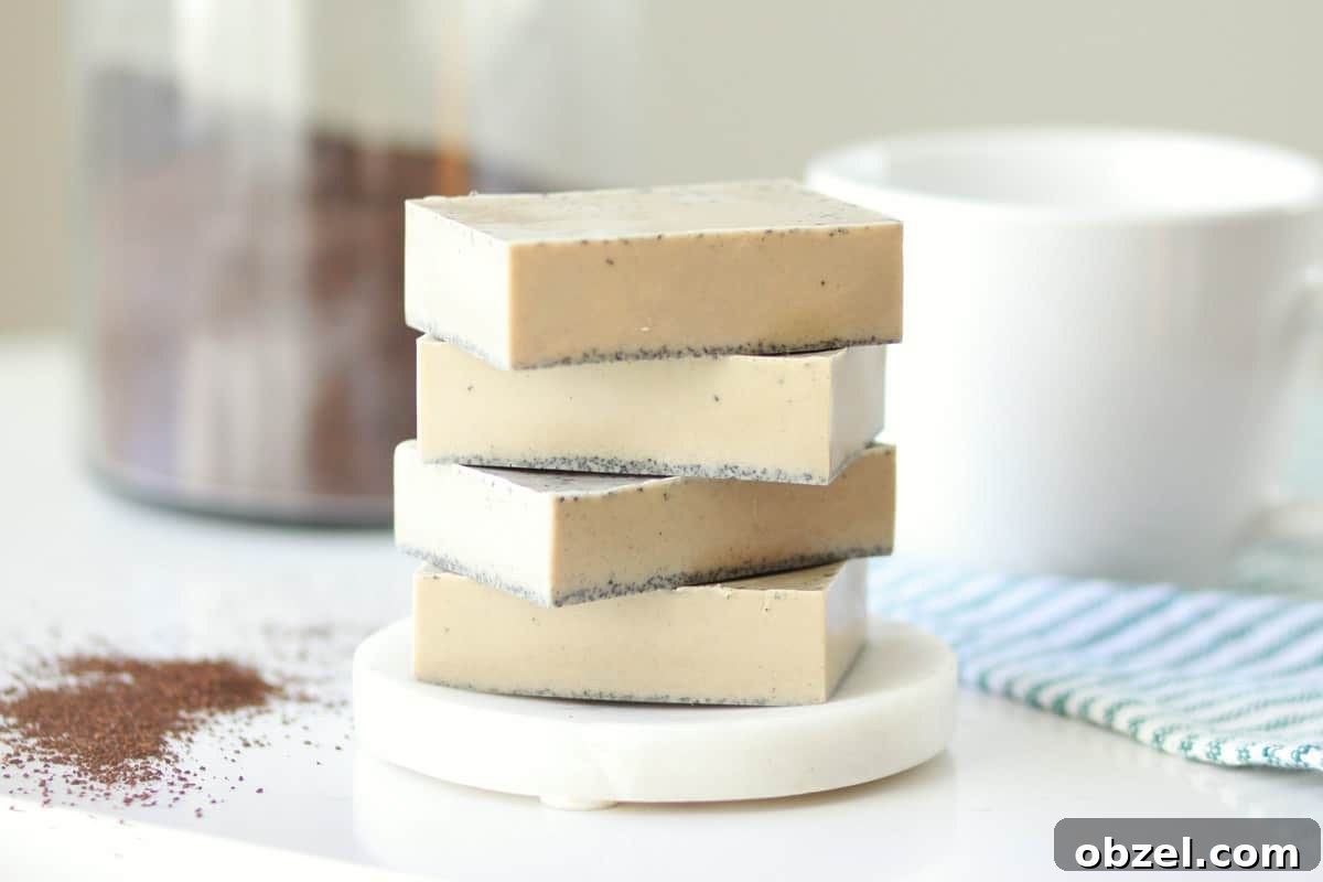 a stack of 4 bars of coffee soap on a soap dish