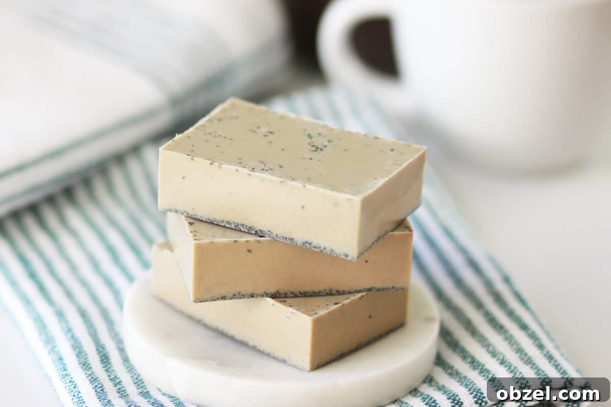 a stack of 4 bars of coffee soap on a soap dish