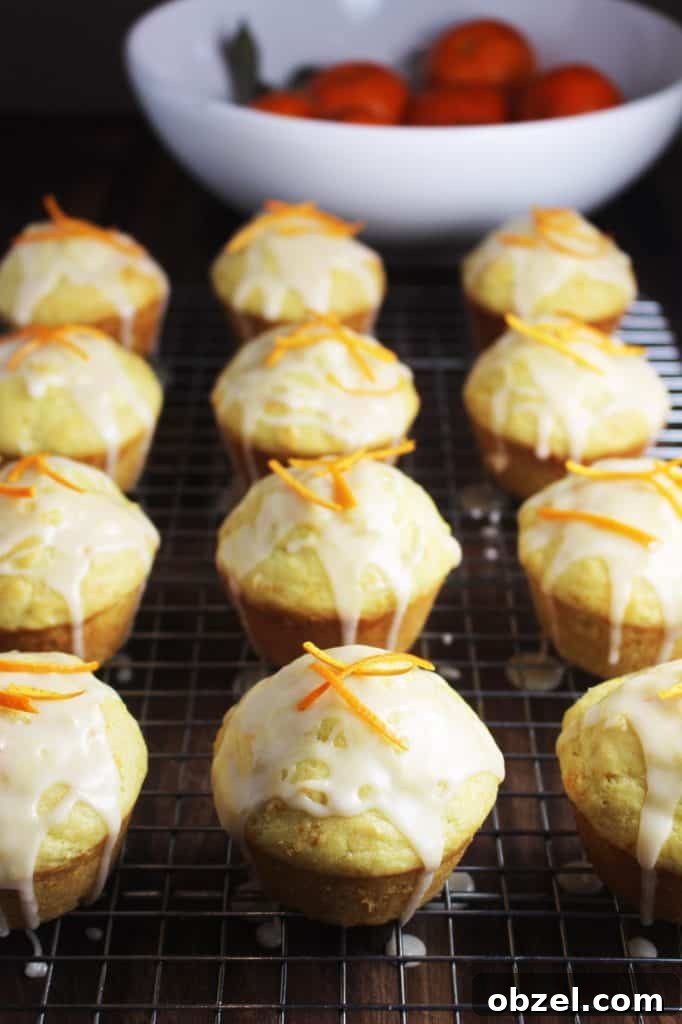 Mandarin Orange Greek Yogurt Muffins 4 a dozen glazed mandarine orange muffins on a cooling rack