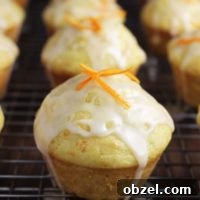 glazed mandarin orange muffins on a cooling rack