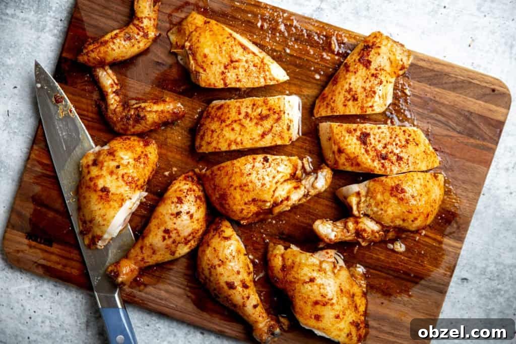Traeger Smoked Whole Chicken Recipe 8 Traeger smoked chicken cut into pieces on a cutting board.