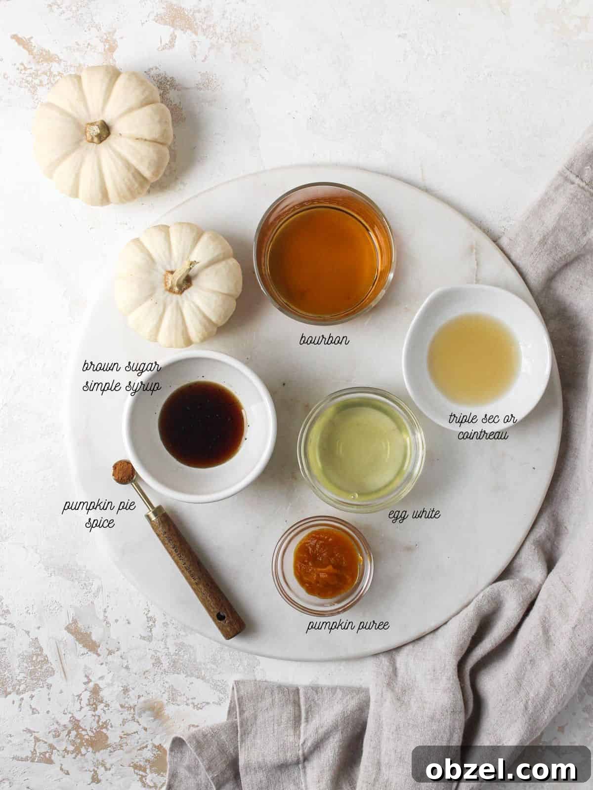 Ingredients to make a bourbon fall cocktail on table.