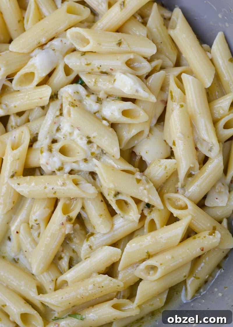 Penne pesto pasta simmering in a creamy sauce