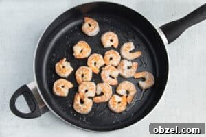 Pineapple Shrimp Fried Rice Recipe 15 Shrimp cooking in a skillet.