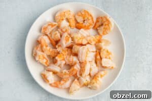 Pineapple Shrimp Fried Rice Recipe 16 Cooked shrimp on a white plate.
