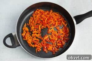 Pineapple Shrimp Fried Rice Recipe 17 Carrots and bell pepper in a skillet.