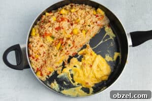 Pineapple Shrimp Fried Rice Recipe 21 Fried rice and scrambled eggs cooking in a skillet.