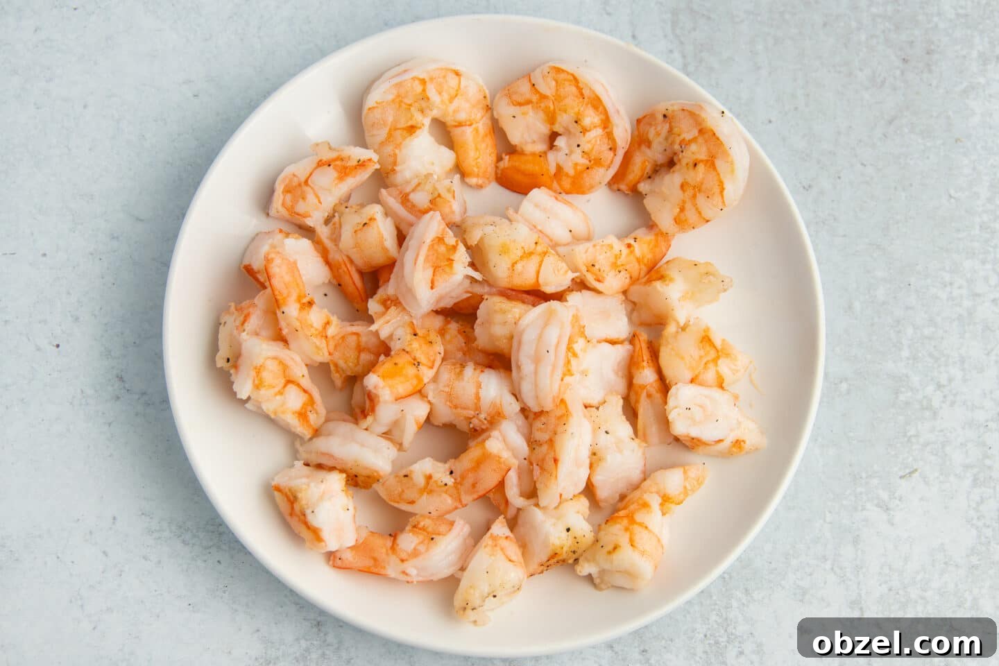 Pineapple Shrimp Fried Rice Recipe 6 Cooked shrimp on a white plate.