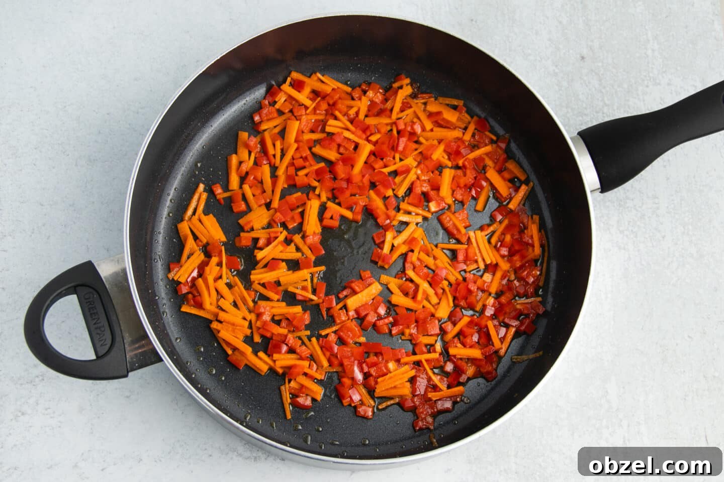Pineapple Shrimp Fried Rice Recipe 7 Carrots and bell pepper cooking in a skillet.