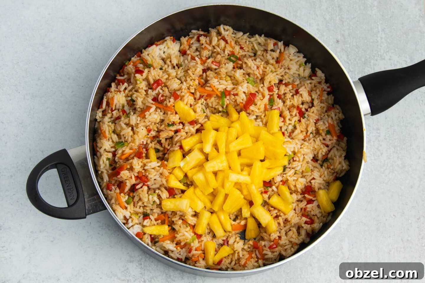 Pineapple Shrimp Fried Rice Recipe 10 Pineapple and soy sauce added to fried rice in a skillet.